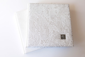 Photobook with a cover of genuine leather. Beautiful white cover with  stamping on white background