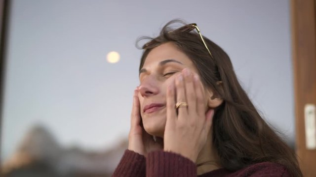 Young Woman Applying Sunscreen Close Up.