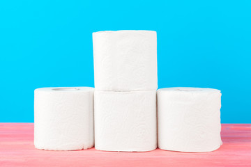 Toilet paper stack on bright blue background