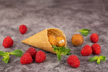 Donuts in waffle cone and raspberry berries