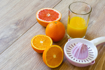 two oranges, reamer and juice