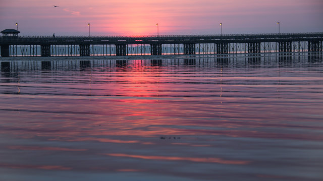 Fototapeta Sun going down: sunset behind Ryde pier