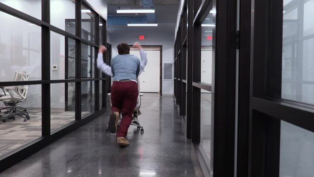 Two Office Workers Celebrating Landing a New Account in the Workplace.