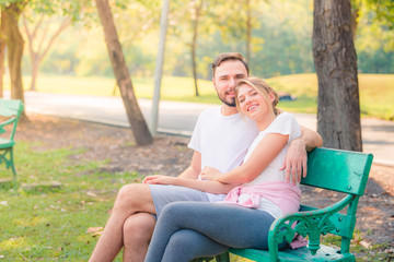 Fototapeta premium Portrait of Young couple enjoying in the park at sunset. Concept romantic and love. Warm tone.