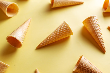Ice cream cornets over yellow background