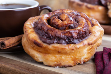 Closeup of a cinnamon roll and cup of coffee