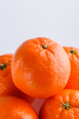 Fototapeta na wymiar juicy mandarin on a white acrylic background