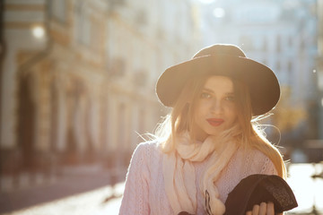 Charming blonde lady wearing sweater and hat. Empty space