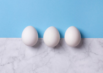 Minimal food composition with eggs on creative background.