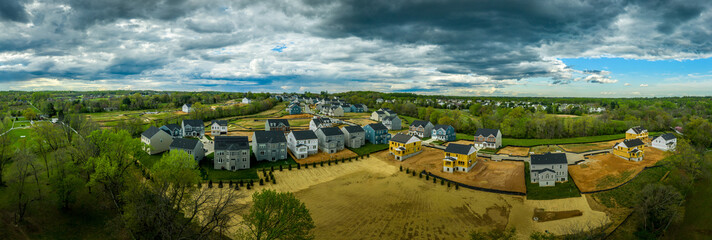 Obraz premium Aerial panorama of new construction luxury residential neighborhood street with American single family homes in Maryland USA real estate