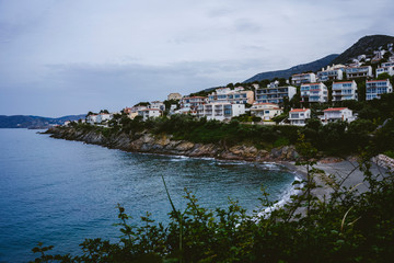 Cloudy coast landscape with houses and near the sea in Catalonia, Spain.