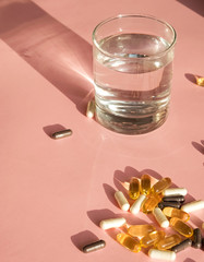 Pills or dietic supplements on the pink backgound