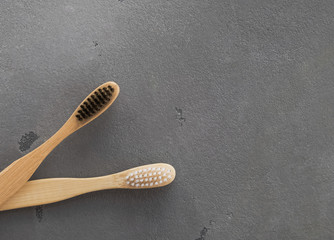 Wooden tooth brushes on the gray background.