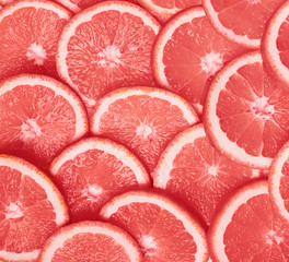 Slices of ripe juicy orange toned in trending coral color.