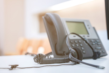 close up soft focus headphone call centre hotline at computer office help desk for background concept.	