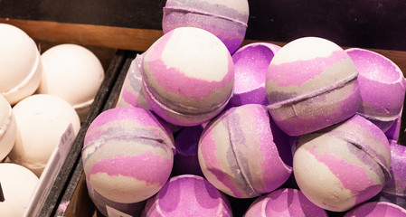 Shop cosmetic handmade bombs and bubble bath different colors. The concept of Spa and relaxation