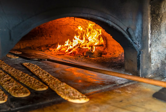 In a restaurant, pita or pide bread cooking in oven or stove. Bakery or bakehouse concept image.