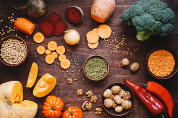 Seasonal food on wooden table. Autumn farm vegetables and legumes