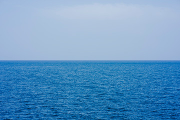 Line of the sea with blue sky completely clear with very soft waves.