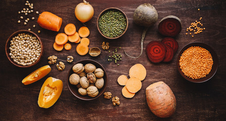 Fototapeta na wymiar Seasonal food on wooden table. Autumn farm vegetables and legumes
