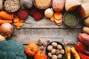 Seasonal food on wooden table. Autumn farm vegetables and legumes