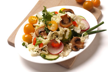 a plate of salad with vegetables, mushrooms and herbs