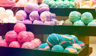 Shop cosmetic handmade bombs and bubble bath different colors. The concept of Spa and relaxation