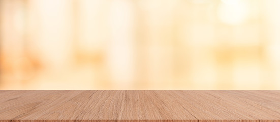 modern brown wood tabletop with blurred restaurant bar cafe light color background for promote and advertise product on display
