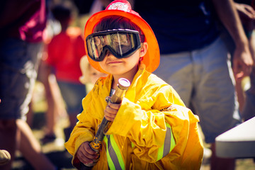 Young Boy dressed in Fire Fighter Gear