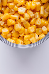 Canned corn in a iron can on white background