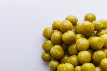 canned green peas on a white acrylic background