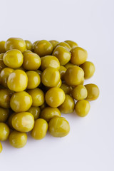 canned green peas on a white acrylic background