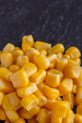 canned corn on a dark stone background
