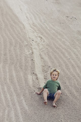 Child coming down on sand at sand Mountain.