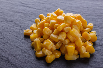 canned corn on a dark stone background