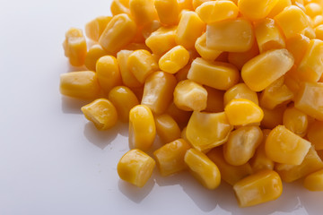 Canned corn on a white acrylic background