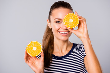 Close up photo beautiful amazing she her lady hold hands arms big large two half slices orange hide one eye new oil extract wash lotion wear blue white striped t-shirt isolated grey background