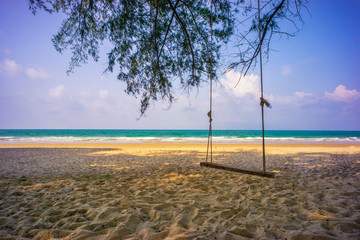 Nature landscape relaxing swing at the Tropical beach and sand with blue sky.
