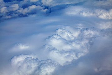 flying above fluffy white clouds