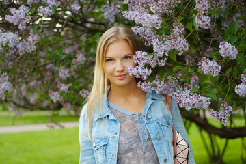 Beautiful blond girl posing in flowers