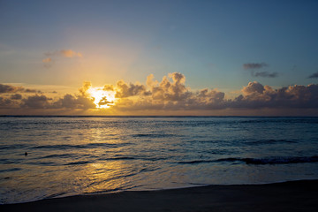 Fototapeta premium Luxury beach hotel, silhouette of palm trees, swimming pool, an beautiful sunrise