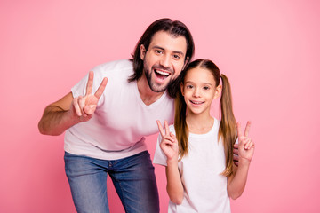 Close up photo beautiful she her little lady stand he him his single dad show v-sign say hi pretty hairstyle vacation rest relax wear casual white t-shirts denim jeans isolated pink bright background