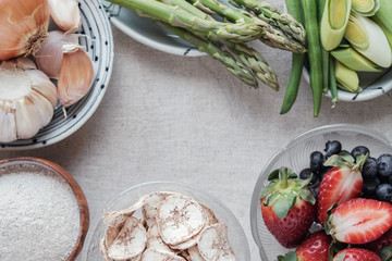 variety of prebiotic foods, raw green banana, asparagus, onions, garlic, leeks, berries and green...