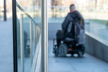 Man in a electric wheelchair using a ramp in blur