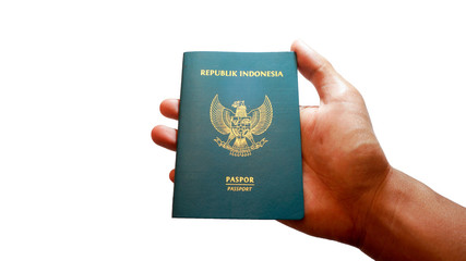 Close up hand holding indonesian passport isolated on white background - Image