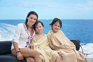 Happy children, brothers, having fun on a boat trip while on holiday