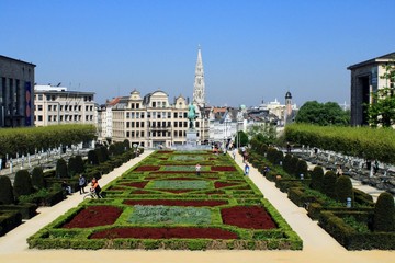 The flower carpet of Mont des Arts in Brussels, under the blue sky, in the background of typical houses in Brussels.