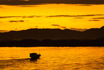 The ship is sailing in the Mekong River in In the morning, the sunrise in the Golden Triangle, Chiang Rai, Thailand