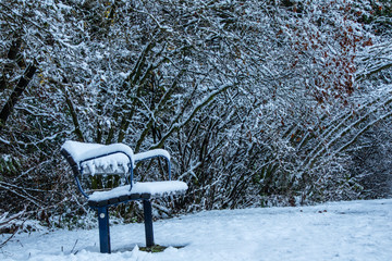 Banco de jardim em um parque congelado com muita neve