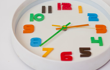  white wall clock with color numbers. colored clock for the children's room